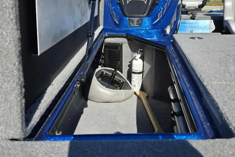 Slide: The Image of 2024 Nitro Z18 boat storage compartment with fire extinguisher and paddle. - 12