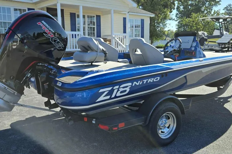 Slide: The Image of 2024 Nitro Z18 boat with Mercury Pro XS engine, parked outdoors. - 3