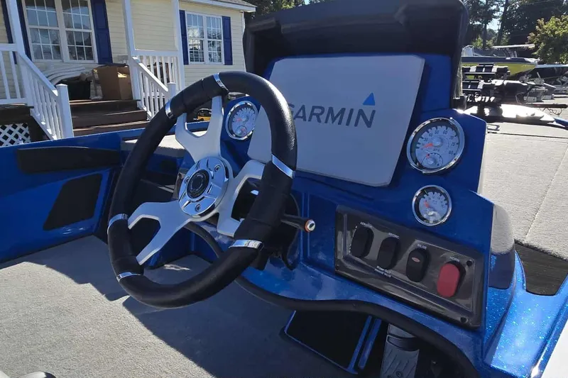 Slide: The Image of 2024 Nitro Z18 boat dashboard with Garmin display and steering wheel. - 8