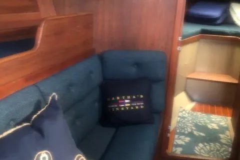 Slide: The Image of Interior of 1988 C&C 44 sailboat with blue cushions and decorative pillows. - 13