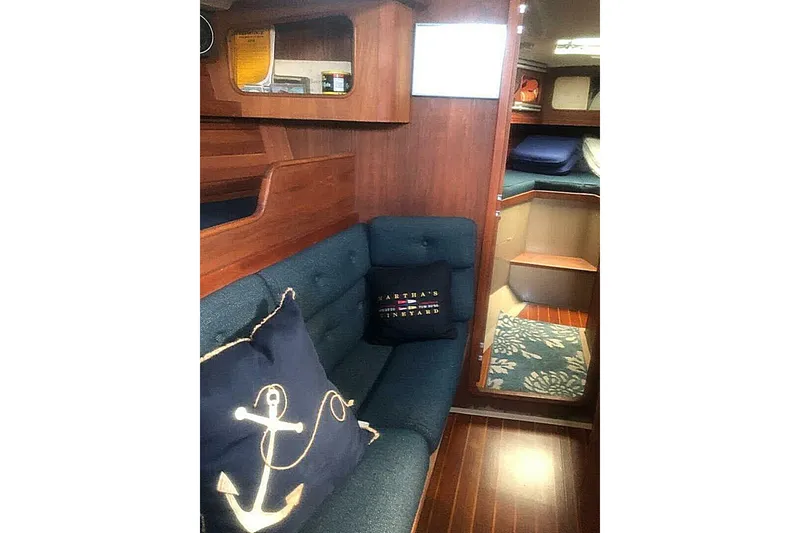 Slide: The Image of Cozy interior of 1988 C&C 44 sailboat with nautical-themed cushions and wooden finish. - 15