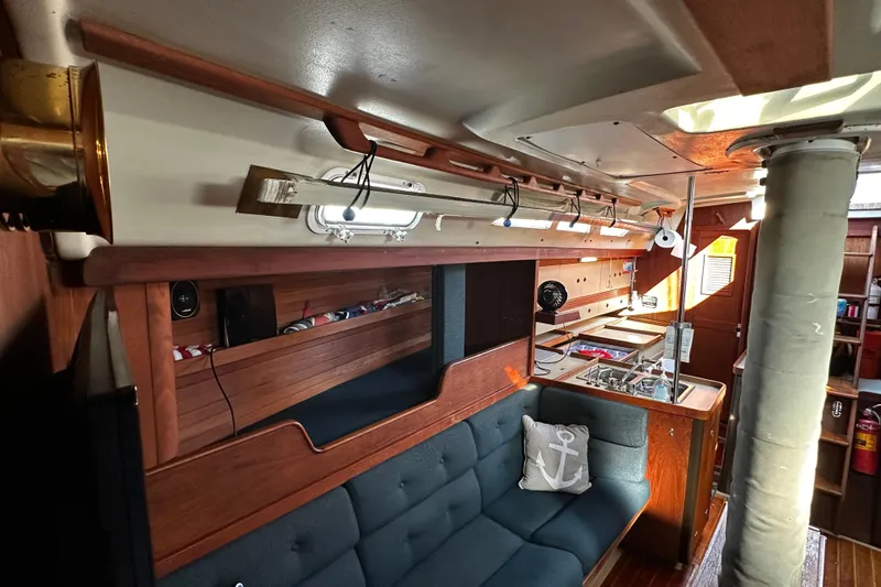 Slide: The Image of Interior of 1988 C&C 44 sailboat with wooden furnishings and cozy seating area. - 22