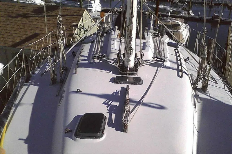 Slide: The Image of 1988 C&C 44 sailboat deck with rigging and hatches in a marina. - 4