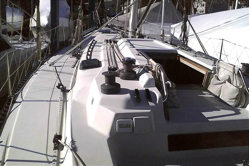 Slide: The Image of 1988 C&C 44 sailboat deck with winches and rigging, docked in a marina. - 5