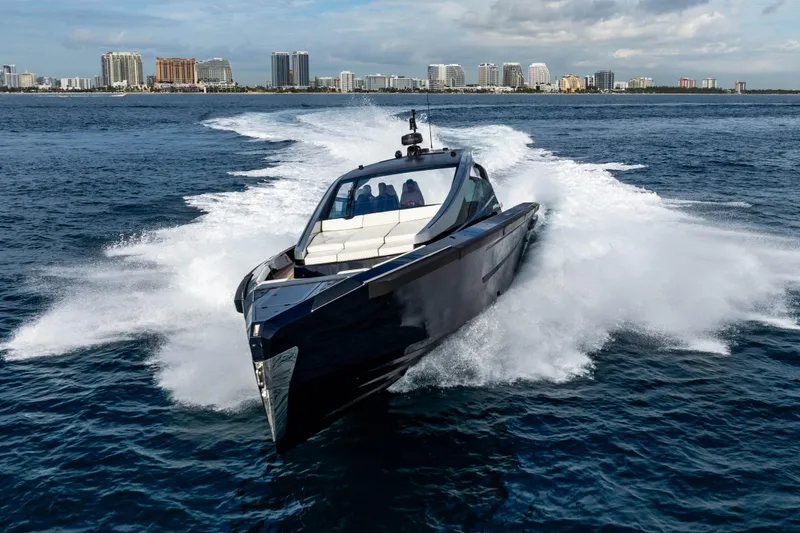 Slide: The Image of Luxury Maori 54 yacht cruising on ocean with city skyline in background, 2023 model. - 11