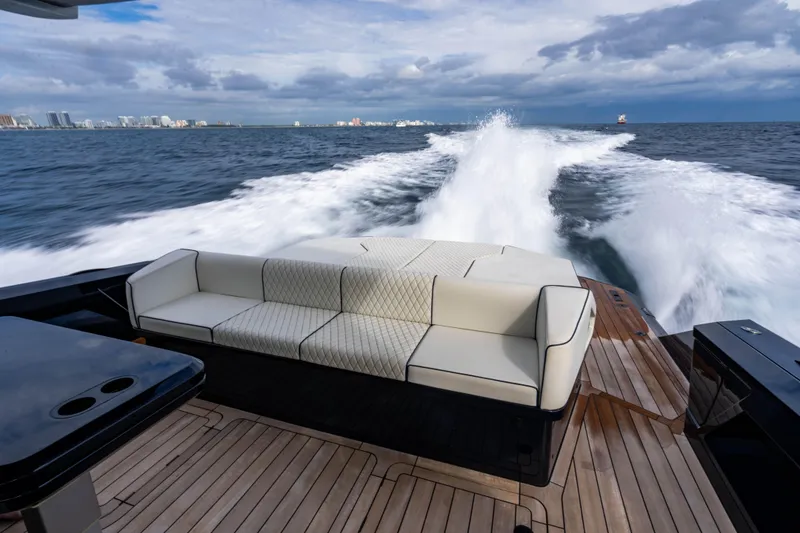 Slide: The Image of Luxury Maori 54 yacht cruising on open sea, featuring elegant deck seating, 2023 model. - 19