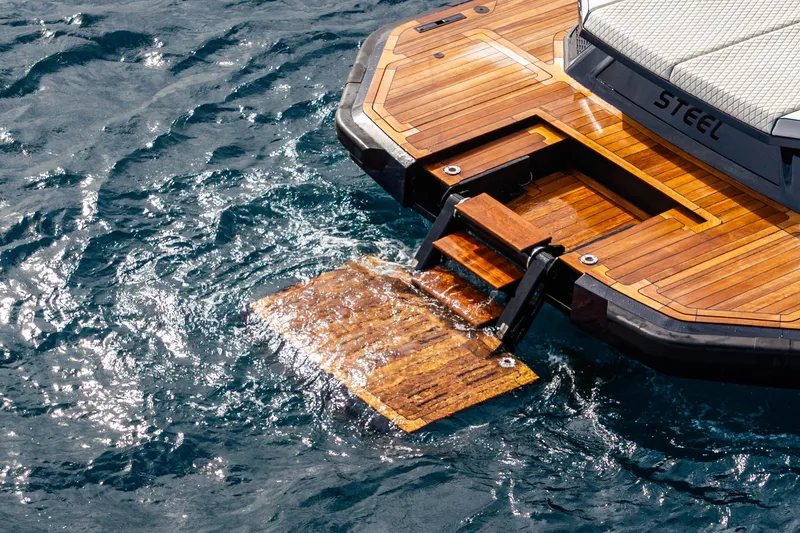 Slide: The Image of Luxury yacht Maori 54, 2023 model, with wooden deck and swim platform on water. - 29