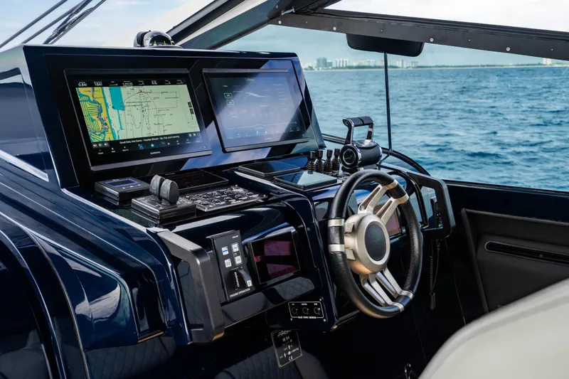 Slide: The Image of Modern Maori 54 yacht cockpit with advanced navigation systems, steering wheel, and ocean view, 2023 model. - 30