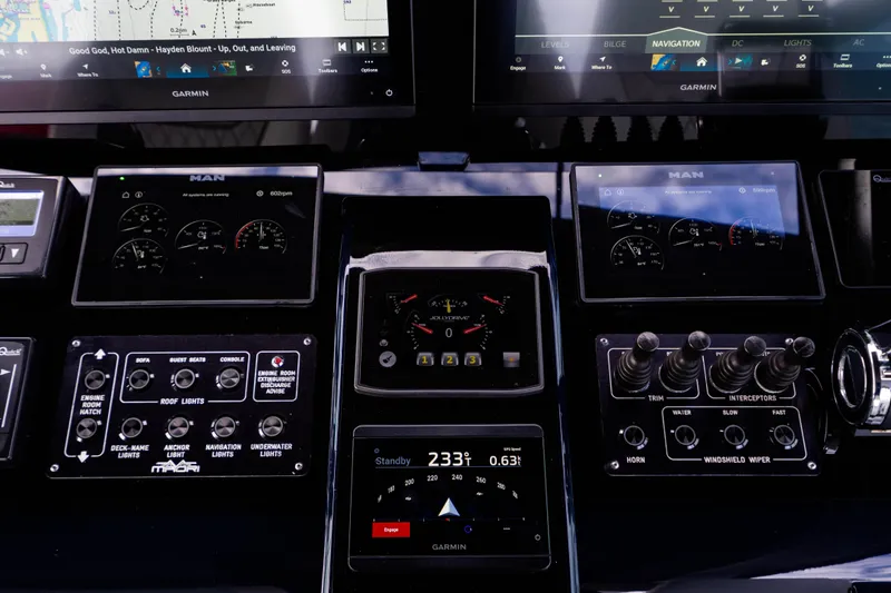Slide: The Image of Control panel of a 2023 Maori 54 yacht with navigation and engine displays. - 34