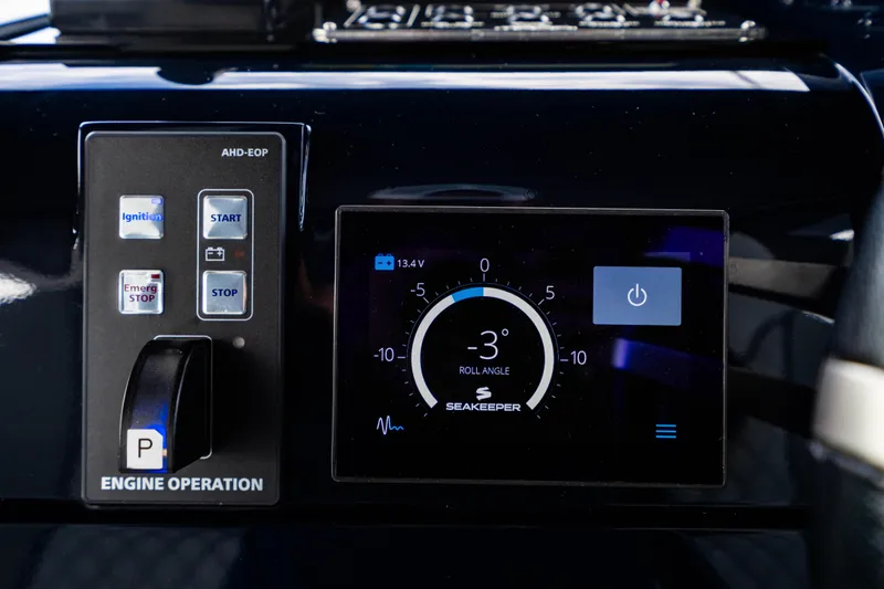 Slide: The Image of Control panel of a 2023 Maori 54 boat with Seakeeper display and engine operation controls. - 35