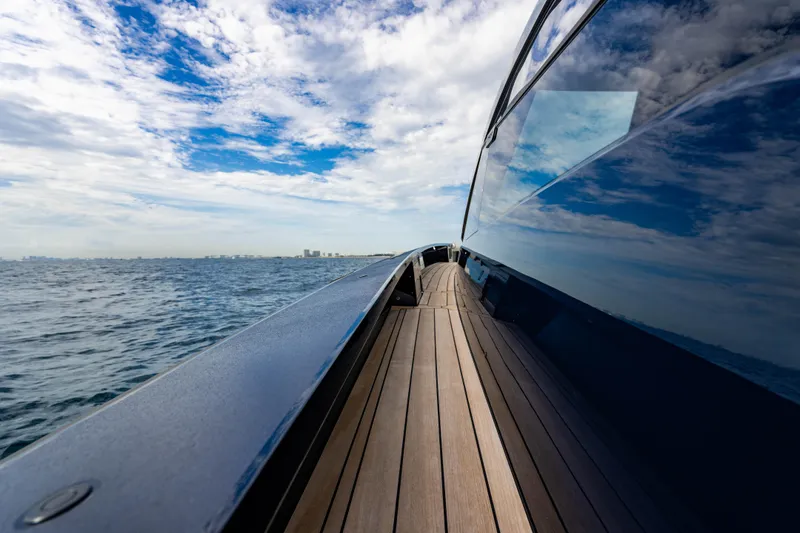 Slide: The Image of Sleek 2023 Maori 54 yacht cruising on open water under a partly cloudy sky. - 36