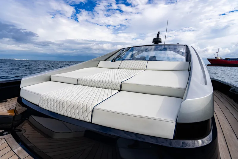 Slide: The Image of Luxurious 2023 Maori 54 yacht with elegant white seating, cruising on open water under a cloudy sky. - 39