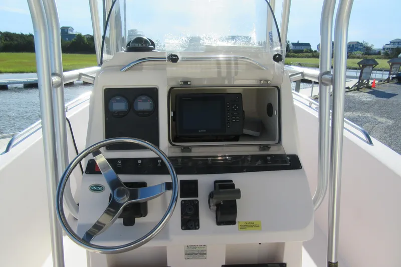 Slide: The Image of 2004 Grady-White Fisherman 222 boat console with steering wheel and navigation equipment. - 3