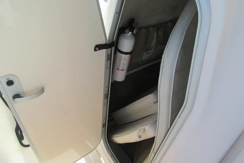 Slide: The Image of Storage compartment with fire extinguisher on 2004 Grady-White Fisherman 222 boat. - 7