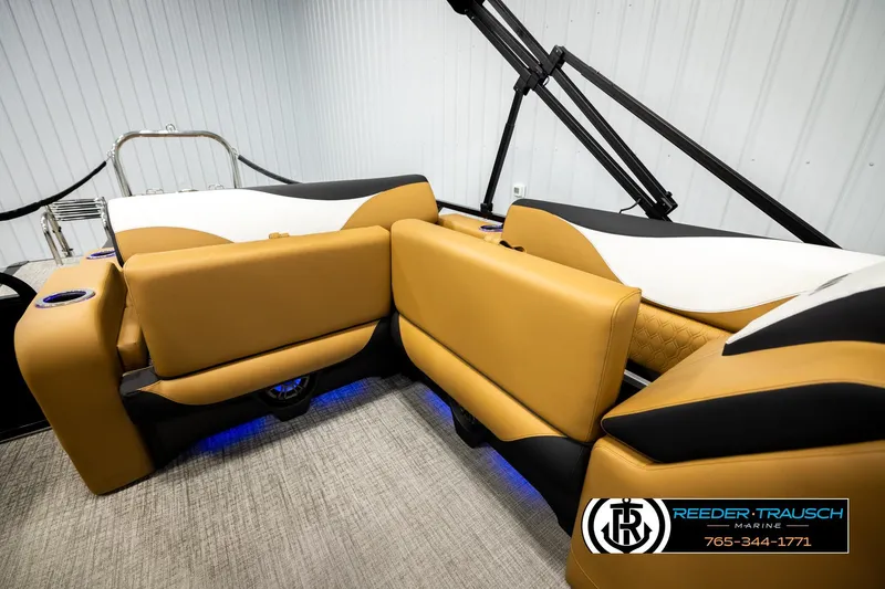 Slide: The Image of 2026 Avalon LSZ VRB boat interior with tan and black seating, blue LED lighting. - 24