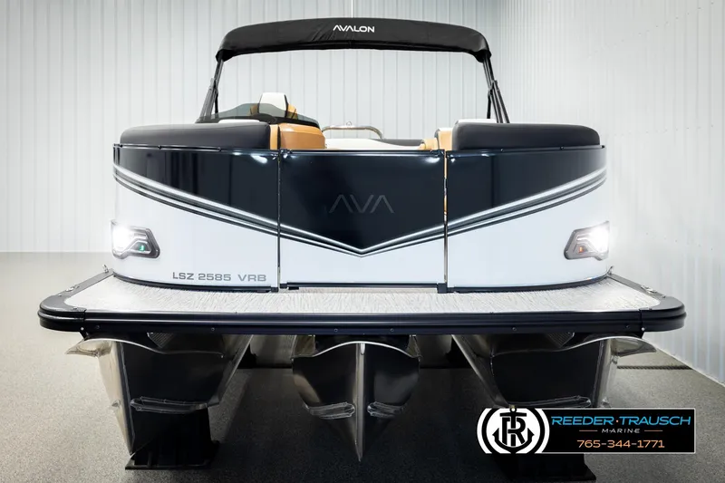 Slide: The Image of 2026 Avalon LSZ VRB pontoon boat in showroom, front view with sleek design. - 8