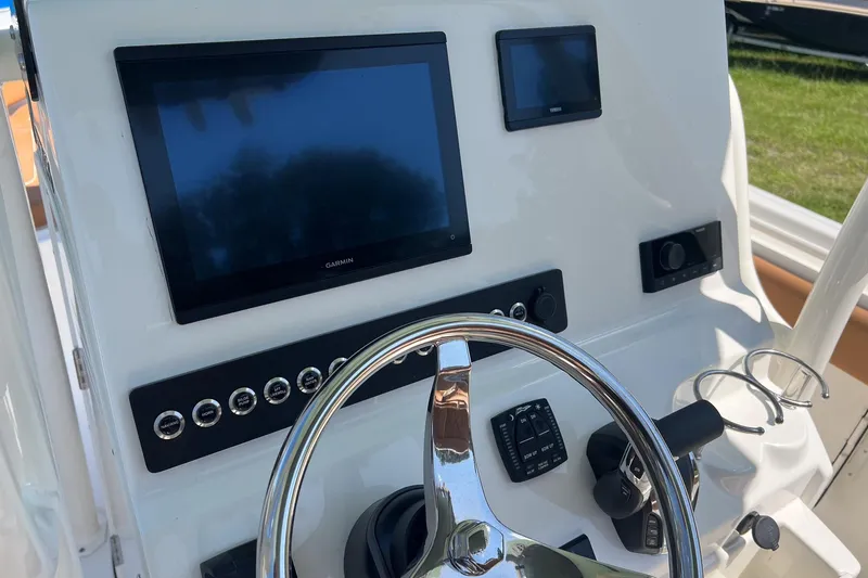 Slide: The Image of 2026 Key West 239 FS boat dashboard with steering wheel and electronic displays. - 14