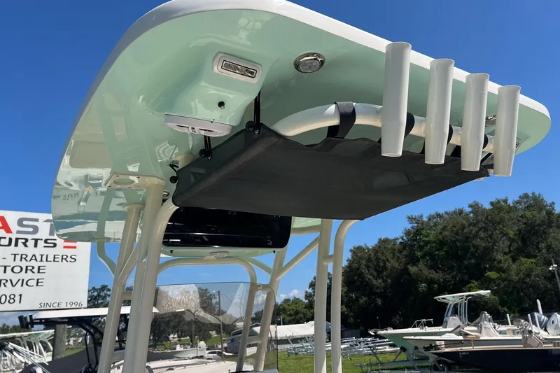 Slide: The Image of 2026 Key West 239 FS boat with rod holders and canopy, displayed outdoors. - 16