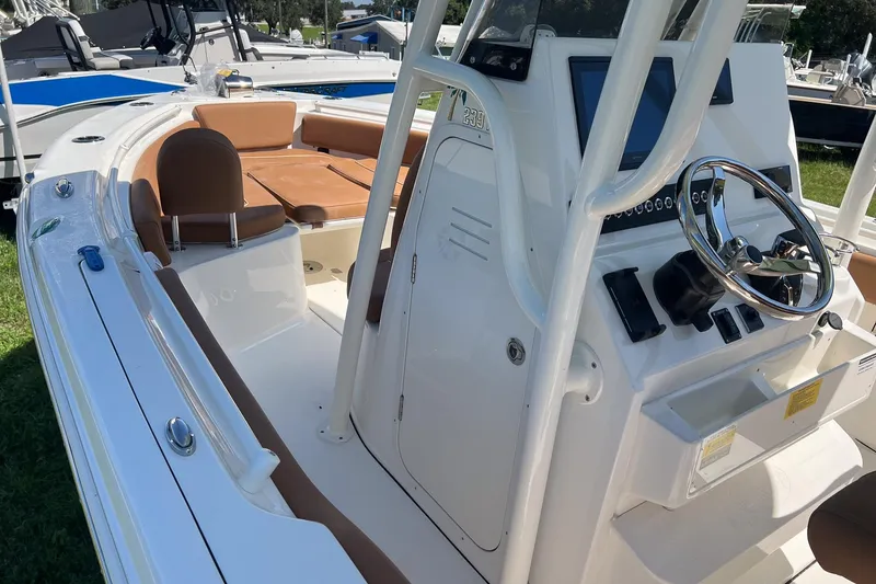Slide: The Image of 2026 Key West 239 FS boat interior with steering console and seating. - 17