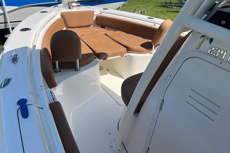 Slide: The Image of 2026 Key West 239 FS boat interior with brown seating and white deck. - 18