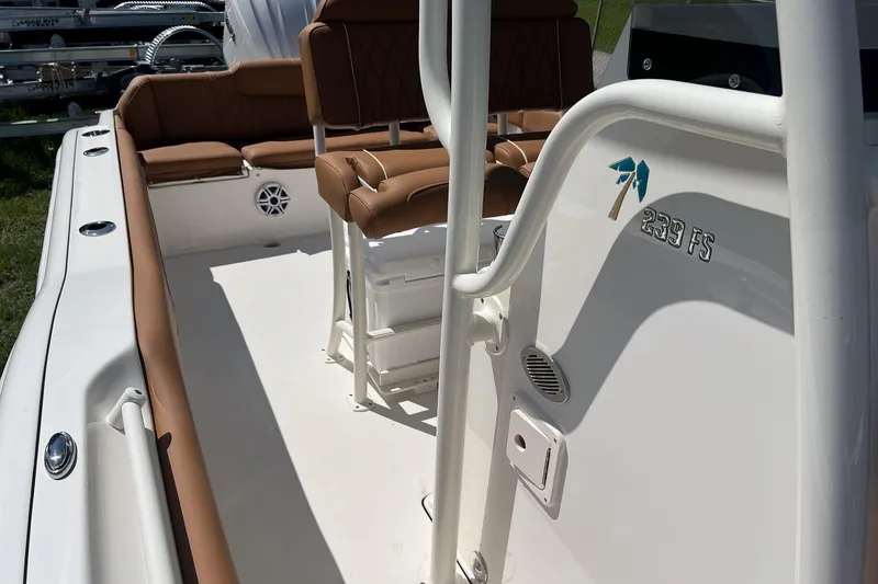 Slide: The Image of 2026 Key West 239 FS boat interior with tan seating and white deck. - 24