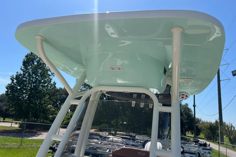 Slide: The Image of 2026 Key West 239 FS boat with sleek T-top design under clear blue sky. - 25