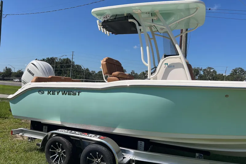 Slide: The Image of 2026 Key West 239 FS boat on trailer, featuring Yamaha engine, light blue hull. - 3