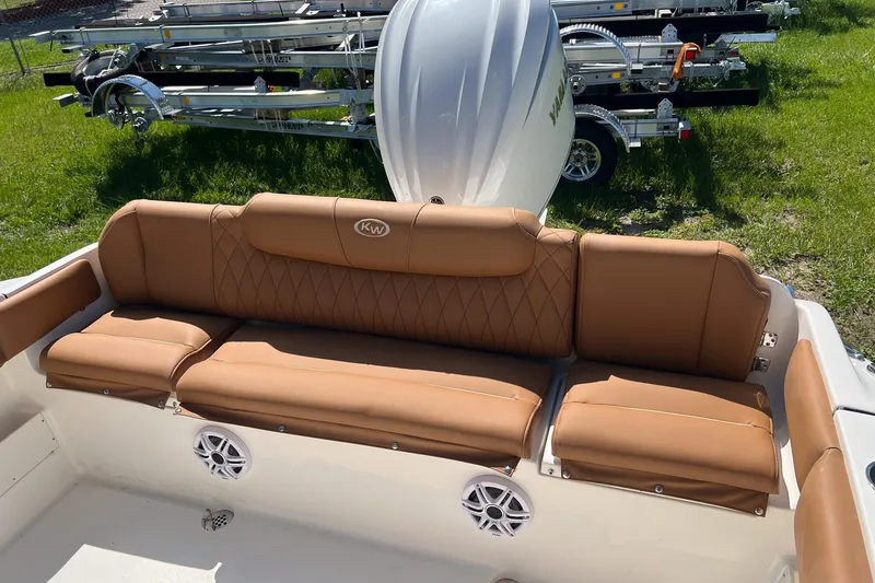 Slide: The Image of 2026 Key West 239 FS boat with tan leather seating and visible engine. - 8