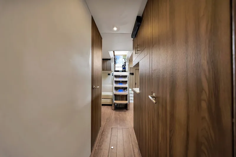 Slide: The Image of Interior hallway of 2017 Regal 53 Sport Coupe yacht with wooden cabinetry. - 66