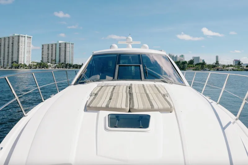 Slide: The Image of 2017 Regal 53 Sport Coupe yacht on water with city skyline in background. - 12