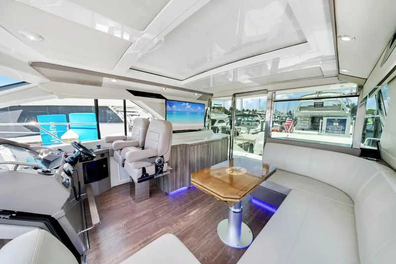 Slide: The Image of Luxurious interior of 2017 Regal 53 Sport Coupe yacht with modern seating and helm. - 13