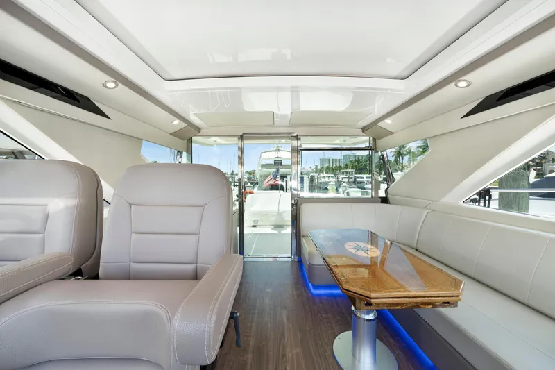Slide: The Image of Luxurious interior of 2017 Regal 53 Sport Coupe yacht with plush seating and elegant table. - 15