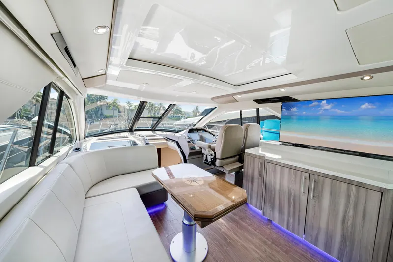 Slide: The Image of Luxurious interior of 2017 Regal 53 Sport Coupe yacht with modern seating and large windows. - 17