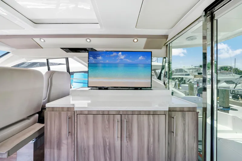 Slide: The Image of Interior of 2017 Regal 53 Sport Coupe yacht with modern cabinetry and TV display. - 19