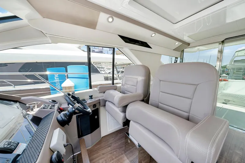 Slide: The Image of Luxurious interior of 2017 Regal 53 Sport Coupe yacht with plush seating and modern controls. - 20