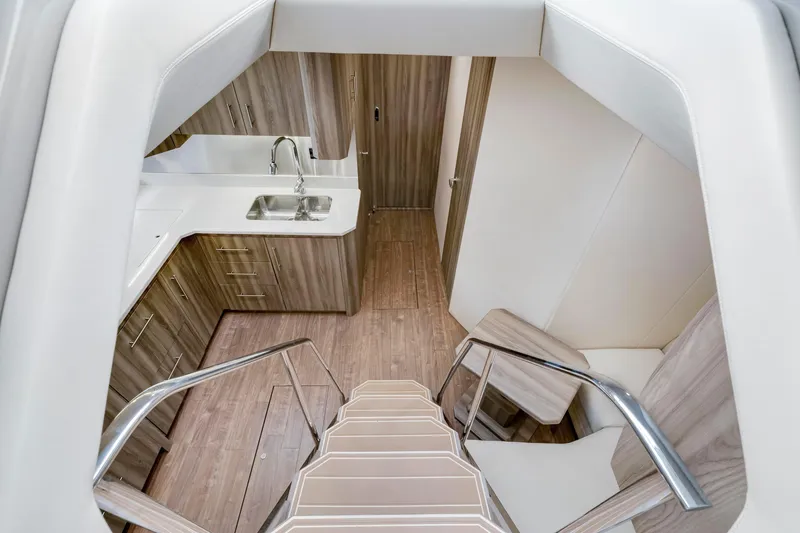 Slide: The Image of Interior of 2017 Regal 53 Sport Coupe yacht with modern kitchen and wooden flooring. - 23
