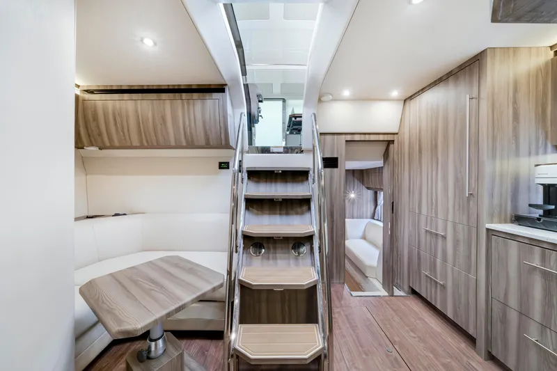 Slide: The Image of Luxurious interior of 2017 Regal 53 Sport Coupe yacht with modern wood finishes. - 24