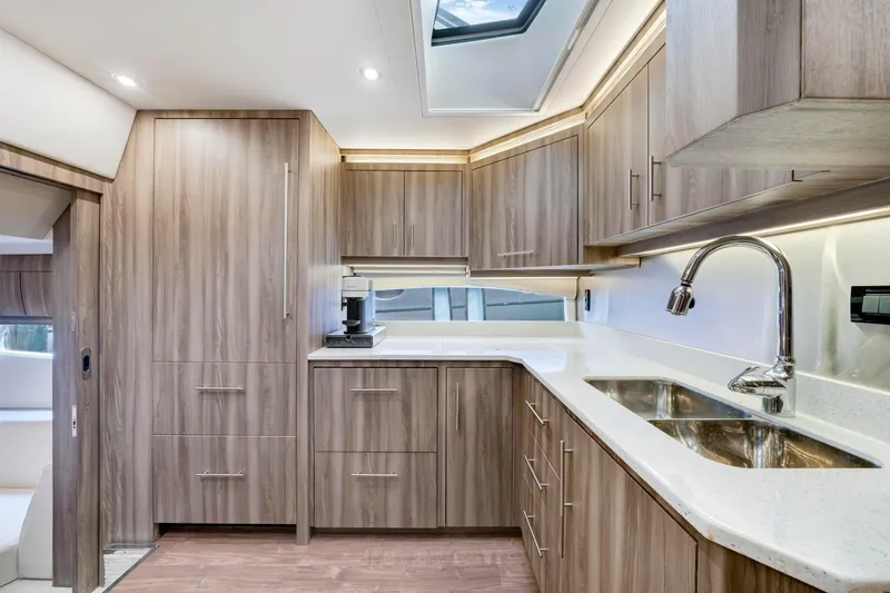 Slide: The Image of Luxurious kitchen interior of 2017 Regal 53 Sport Coupe yacht with modern wood cabinetry. - 26