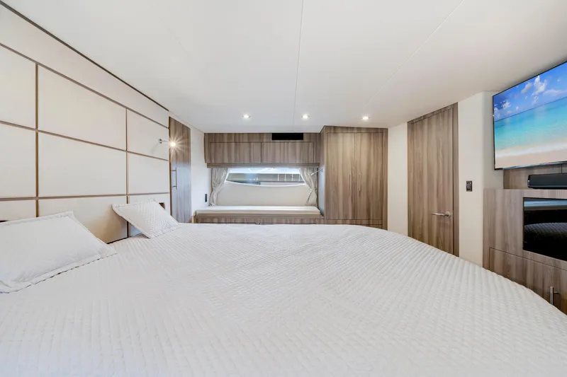 Slide: The Image of Luxurious bedroom interior of 2017 Regal 53 Sport Coupe yacht, featuring modern design and amenities. - 29
