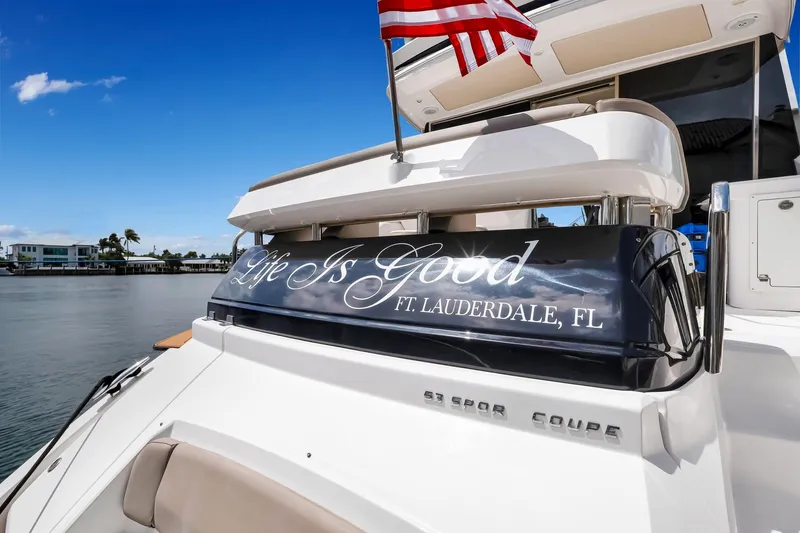 Slide: The Image of 2017 Regal 53 Sport Coupe yacht with "Life Is Good" text, docked in Ft. Lauderdale. - 26