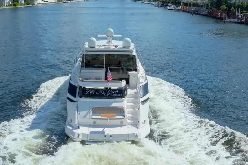 Slide: The Image of 2017 Regal 53 Sport Coupe yacht cruising on a scenic waterway. - 3