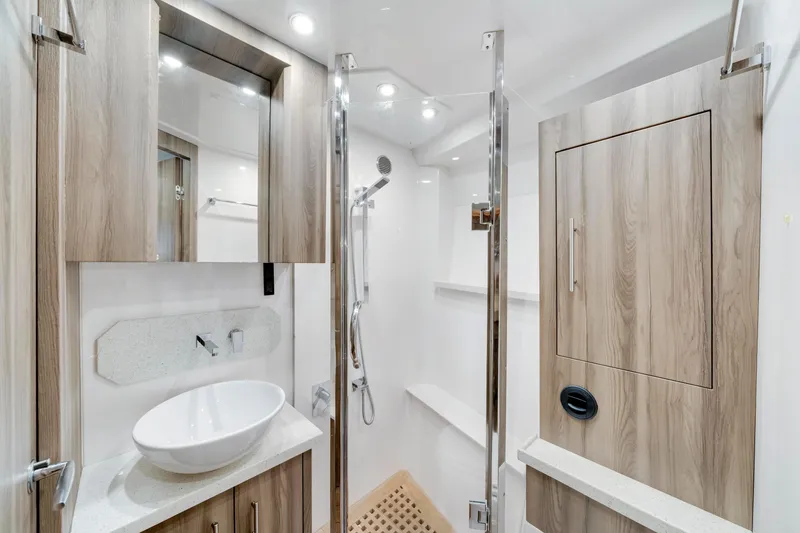 Slide: The Image of Luxurious bathroom in 2017 Regal 53 Sport Coupe yacht with modern fixtures and wood accents. - 32