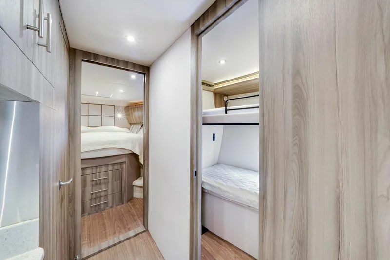 Slide: The Image of Interior of 2017 Regal 53 Sport Coupe with bunk beds and modern wood finish. - 34