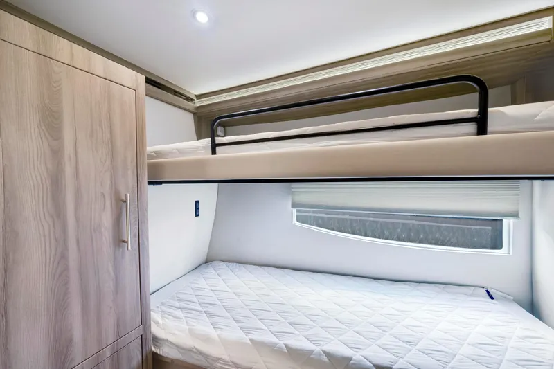 Slide: The Image of Bunk beds in 2017 Regal 53 Sport Coupe yacht interior, featuring modern design and wood finish. - 35
