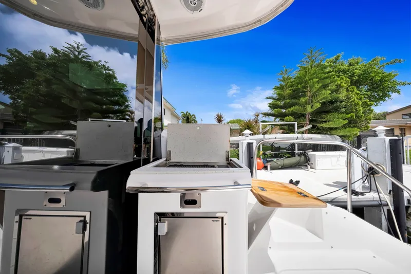 Slide: The Image of 2017 Regal 53 Sport Coupe yacht with outdoor kitchen and scenic view. - 34