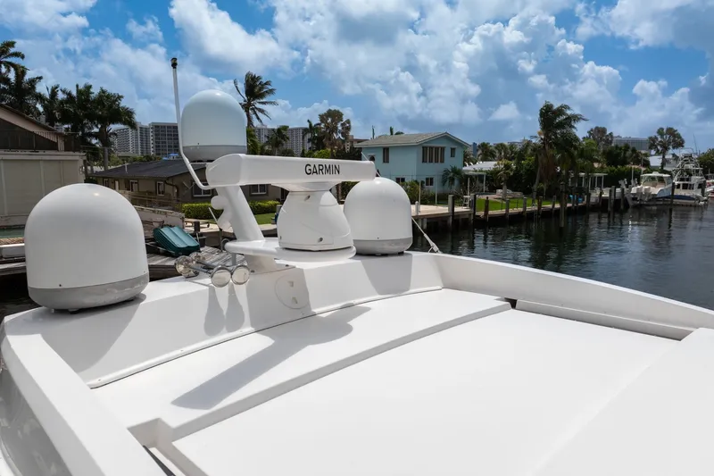 Slide: The Image of 2017 Regal 53 Sport Coupe yacht with Garmin radar, docked near waterfront homes. - 22