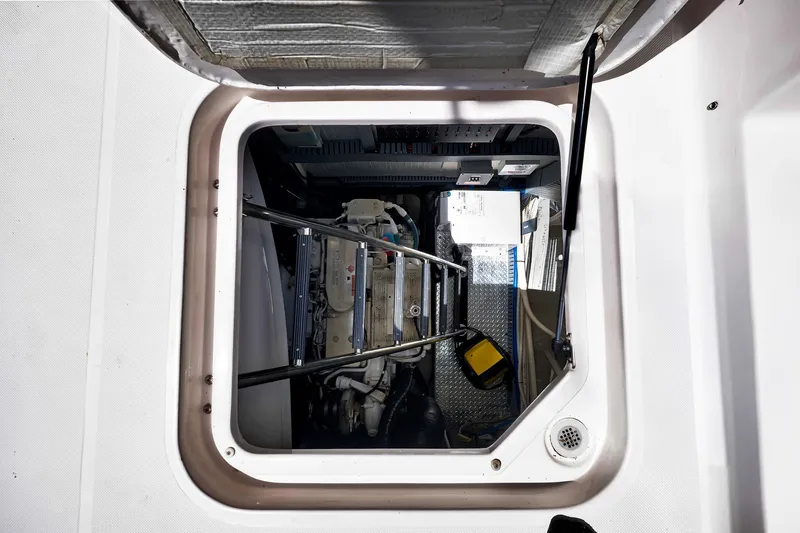 Slide: The Image of Engine compartment of a 2017 Regal 53 Sport Coupe yacht, showcasing mechanical components. - 80