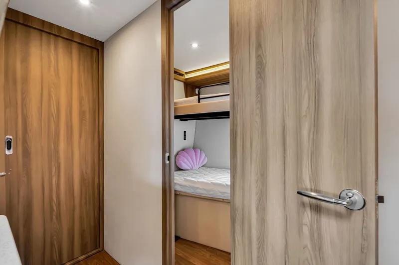 Slide: The Image of Interior of 2017 Regal 53 Sport Coupe showing cozy cabin with bunk bed. - 67