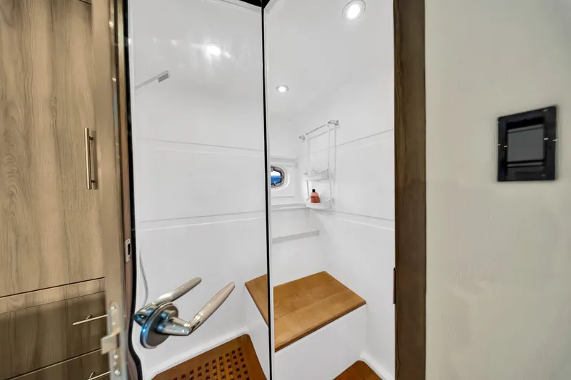 Slide: The Image of 2017 Regal 53 Sport Coupe shower area with wooden accents and modern fixtures. - 75
