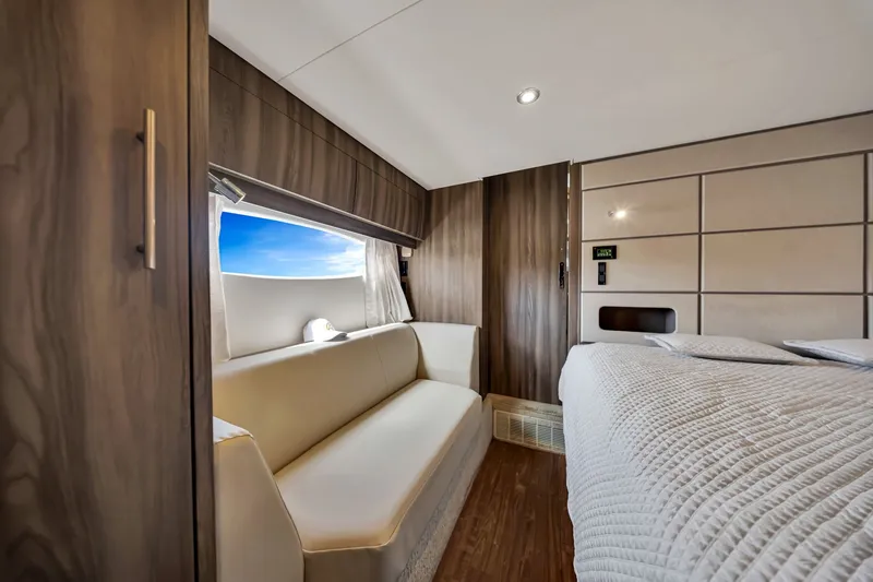 Slide: The Image of Luxurious interior of 2017 Regal 53 Sport Coupe with elegant seating and bedding. - 72